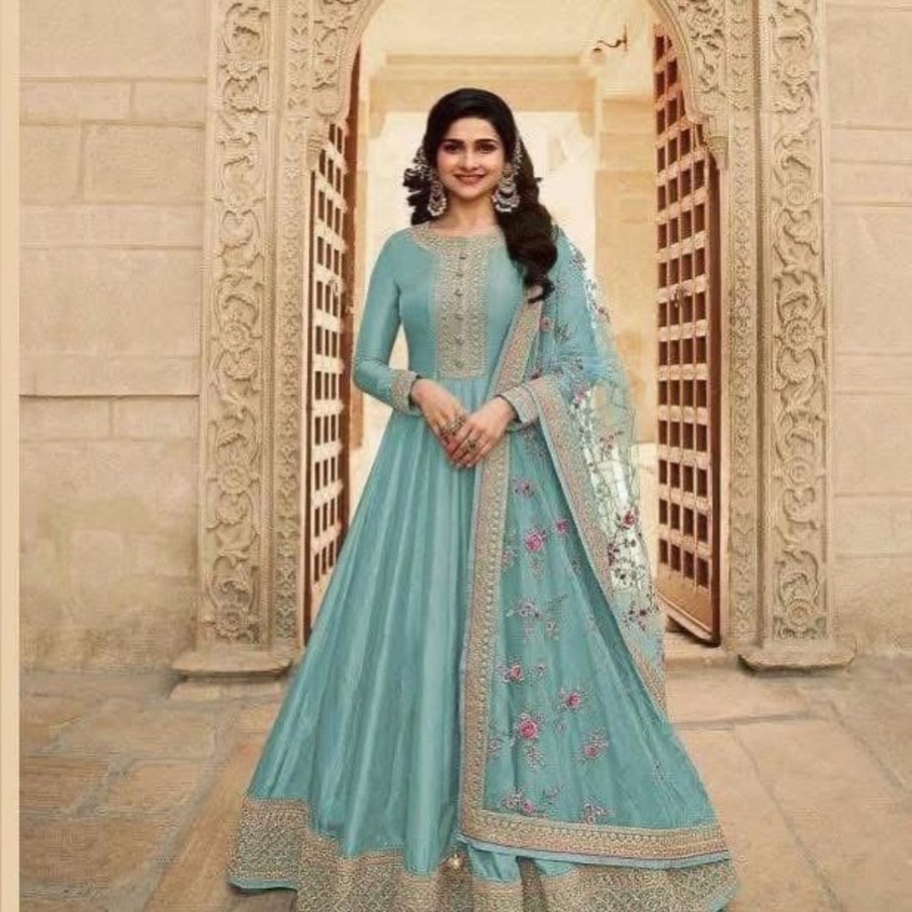 Turquoise gown with net Dupatta.